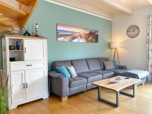 a living room with a couch and a table at Lohme - Doppelhaushälfte Svantevit 2 in Ranzow in Ranzow