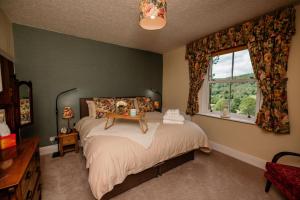 a bedroom with a bed with a table on it at George's Cottage in Bamford