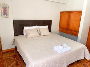 a bedroom with a bed with a box of tissues on it at Hotel Cordillera Blanca in Caraz