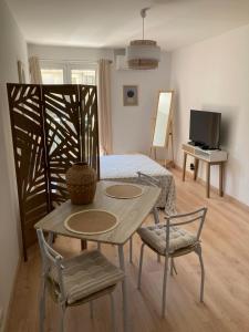 Cette chambre comprend un lit, une table et des chaises. dans l'établissement STUDIO COURS GENERAL LECLERC, à Ajaccio