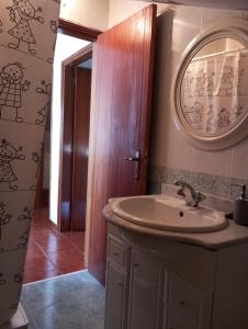 uma casa de banho com um lavatório e um espelho em Sótão dos Avós do Monte Beatriz em Reguengos de Monsaraz