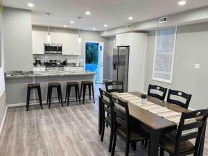 a kitchen and dining room with a table and chairs at completely remodeled 4 bedrooms 2.5 baths in Baltimore