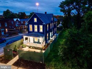 a large blue house in a residential neighborhood at completely remodeled 4 bedrooms 2.5 baths in Baltimore