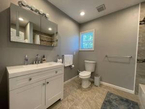 a bathroom with a toilet and a sink and a shower at completely remodeled 4 bedrooms 2.5 baths in Baltimore +55 photos