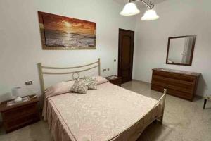 a bedroom with a bed and a dresser and a mirror at Stella Marina in Montesilvano