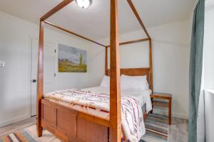 a bedroom with a canopy bed with a wooden frame at Tranquil Edgewood Retreat with Patio and Grill! in Edgewood