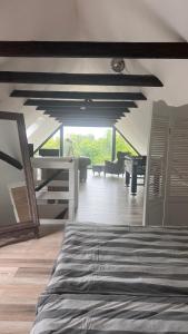 a bedroom with a bed and a living room at Ferienhaus Villa Vogelsang (Schlei / Ostsee) in Stoltebüll