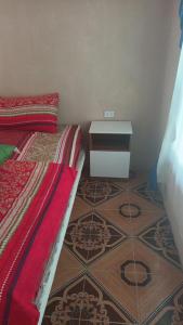 a bedroom with a bed and a dresser on the floor at Hogar media luna in Taxisco