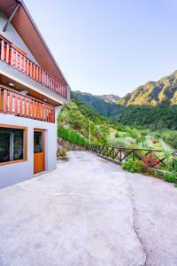 a driveway outside of a house with mountains in the background at Villa Fontes 7 in Ponta Delgada