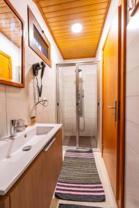 a bathroom with a sink and a shower at Villa Fontes 7 in Ponta Delgada