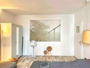 ハノーファーにあるMini City Apartmentの壁に架けられた橋の絵画が施されたベッドルーム
