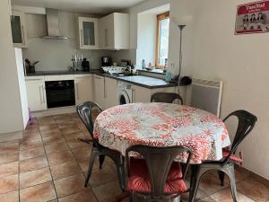 a kitchen with a table and chairs and a table and a kitchen with a counter at Charmant Penty Breton, entre terre et mer, Tregunc in Trégunc +19 photos