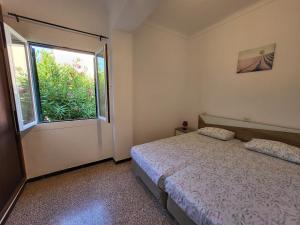 a bedroom with a bed and a window at Casa Serrans in Cala Mesquida