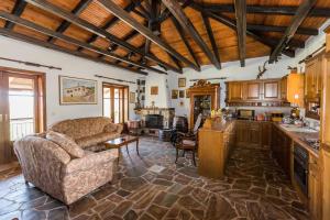 a living room with a couch and a table at Pontinos Villa in Myloi