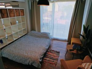 a bedroom with a bed and a large window at Self Check-IN Free Parking Near Metro Stations and BUS WestSide Studio S6 in Bucharest