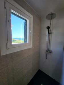 a bathroom with a window and a shower at Casa Serrans in Cala Mesquida