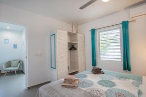 a bedroom with a bed with towels on it at Paradise Apartments - Curacao in Fontein