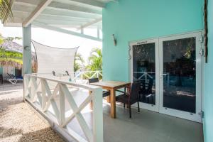 a dining room with a table on a balcony at Paradise Apartments - Curacao in Fontein