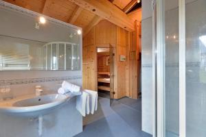 a bathroom with a sink and a glass shower at Landhaus Kostenzer mit Sauna in Fügen +33 photos