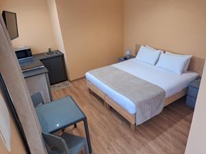 a small room with a bed and a chair at Calheta Countryside in Calheta