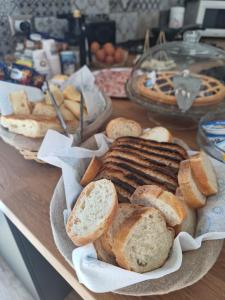 una mesa cubierta con panes y cestas de pan en B&B Magnolia Bari, en Bari