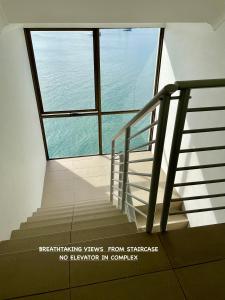 a staircase in a building with a large window at Noosa Shores apt 29-Noosa Heads-near Hastings St in Noosa Heads
