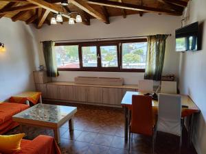 a living room with a couch and a table at Patitiri Central Appartment Evaero in Patitiri