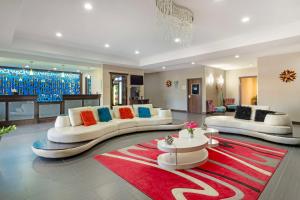 a living room with two couches and a red rug at Best Western Plus Pleasanton Hotel in Pleasanton