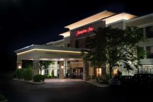 a hotel with a sign on the front of it at night at Hampton Inn Marion in Marion