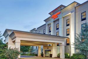 a hotel building with a sign on it at Hampton Inn Lewisburg in Lewisburg
