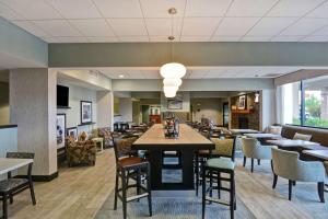 a dining area with tables and chairs in a restaurant at Hampton Inn Lewisburg in Lewisburg