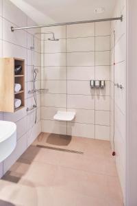 a bathroom with a shower and a sink at Hampton By Hilton Barcelona Fira Gran Via in Hospitalet de Llobregat