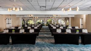 a row of tables and chairs in a room at The Leta Santa Barbara Goleta, Tapestry Collection by Hilton in Santa Barbara +37 photos