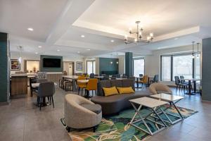 a lobby with a couch and chairs and tables at Best Western Plus Fort Worth North in Fort Worth