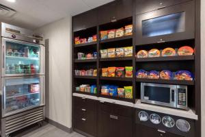 a kitchen with a refrigerator and a microwave at Best Western Plus Fort Worth North in Fort Worth