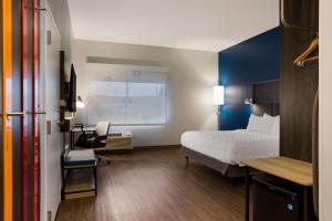 a hotel room with a bed and a desk at Tru By Hilton Traverse City in Traverse City