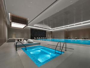 a large swimming pool with a large blue pool at Hilton Zhuji in Zhuji