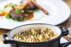 a pot of food on a table with a plate of food at The Old Stocks Inn in Stow on the Wold