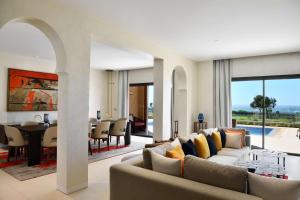 a living room with a couch and a dining room at Hilton Taghazout Bay Beach Resort & Spa in Taghazout