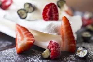 a piece of cake with fruit on a table at The Old Stocks Inn in Stow on the Wold