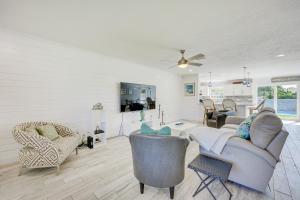 a living room with a couch and chairs at Modern Coastal Home with Pool Mins to Beach and Mayo! in Jacksonville Beach