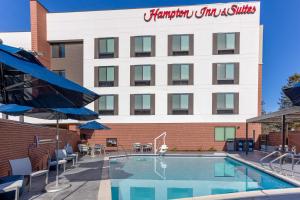 a hotel with a swimming pool in front of a building at Hampton Inn & Suites Santa Rosa Sonoma Wine Country in Santa Rosa