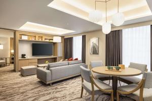 a living room with a couch and a table at DoubleTree by Hilton Toyama in Toyama