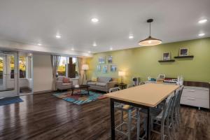 a living room with a table and a couch at WoodSpring Suites Milwaukee - Menomonee Falls in Milwaukee
