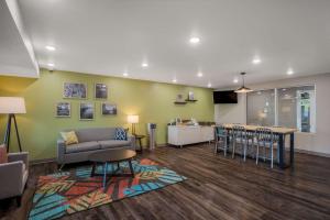 a living room with a couch and a table at WoodSpring Suites Milwaukee - Menomonee Falls in Milwaukee