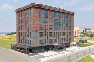 a large brick building on the side of a road at Hampton By Hilton Cerkezkoy in Tekirdag