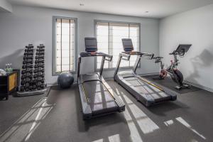 a gym with two treadmills and two exercise bikes at Wylie Hotel Atlanta, Tapestry Collection by Hilton in Atlanta