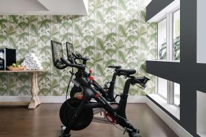 an exercise bike in a room with a wall at Nautilus Sonesta Miami Beach in Miami Beach