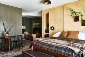 a bedroom with a bed and a living room at Bluebird Cady Hill Lodge in Stowe