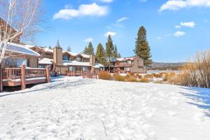 a snow covered yard in front of a house at 013 - Mountain Haven Condo in Big Bear Lake